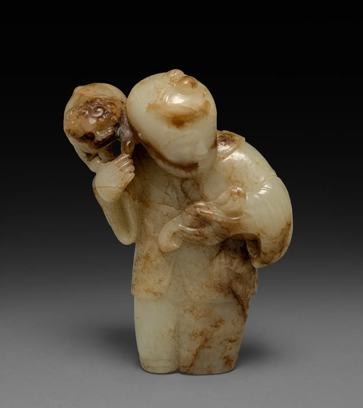 Pale green and brown mottled jade carving of Liu Haichan with a toad.