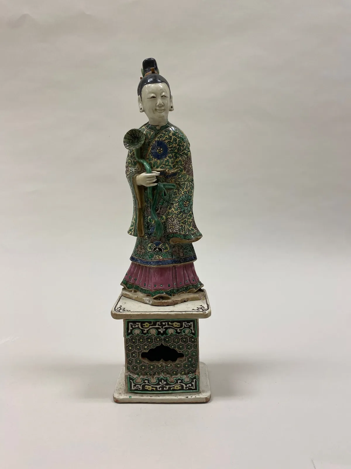 Polychrome ceramic figure of He Xiangu standing in flowing robes.