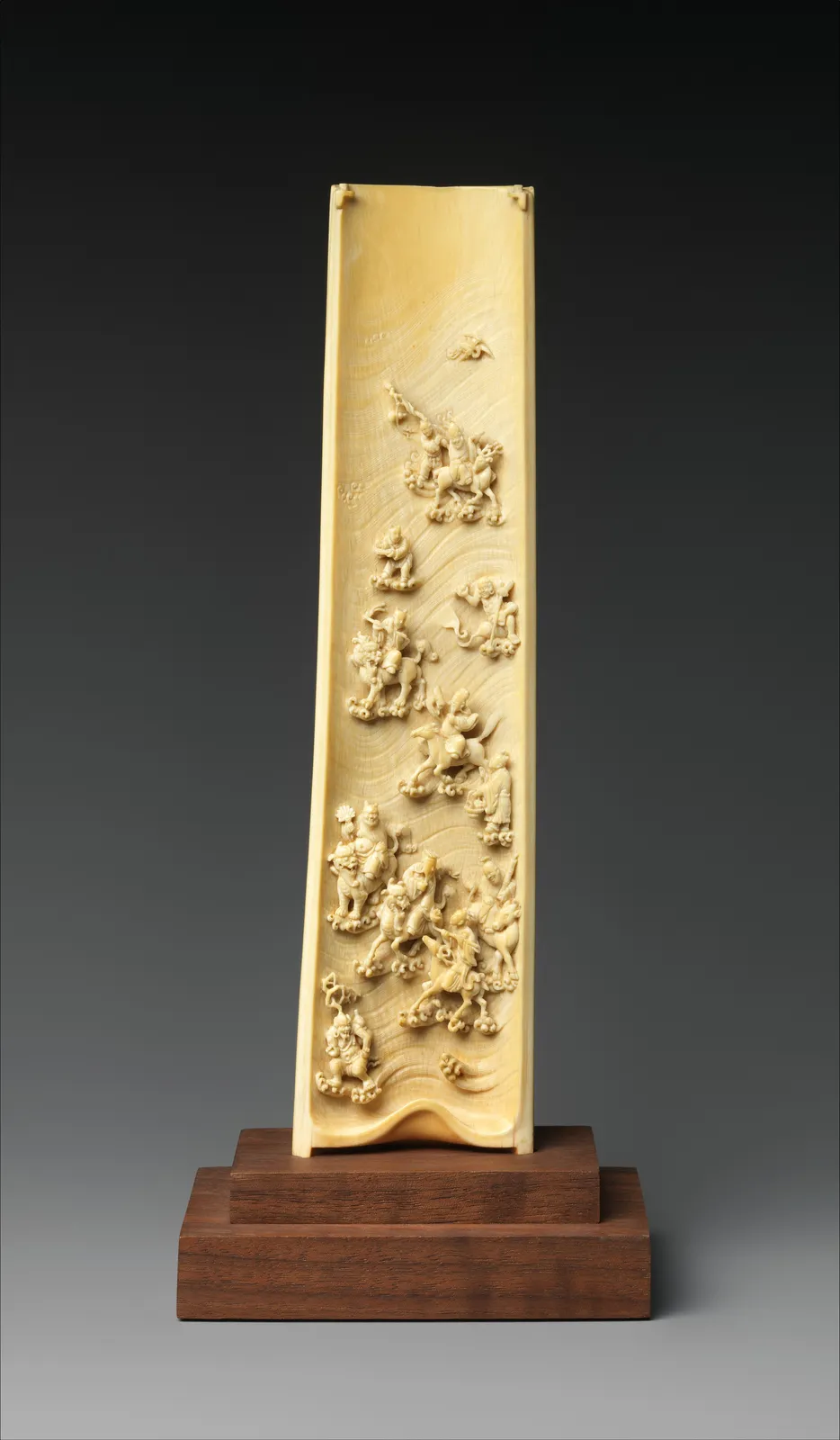 Ivory wrist rest carved with a seascape and the Eight Immortals.